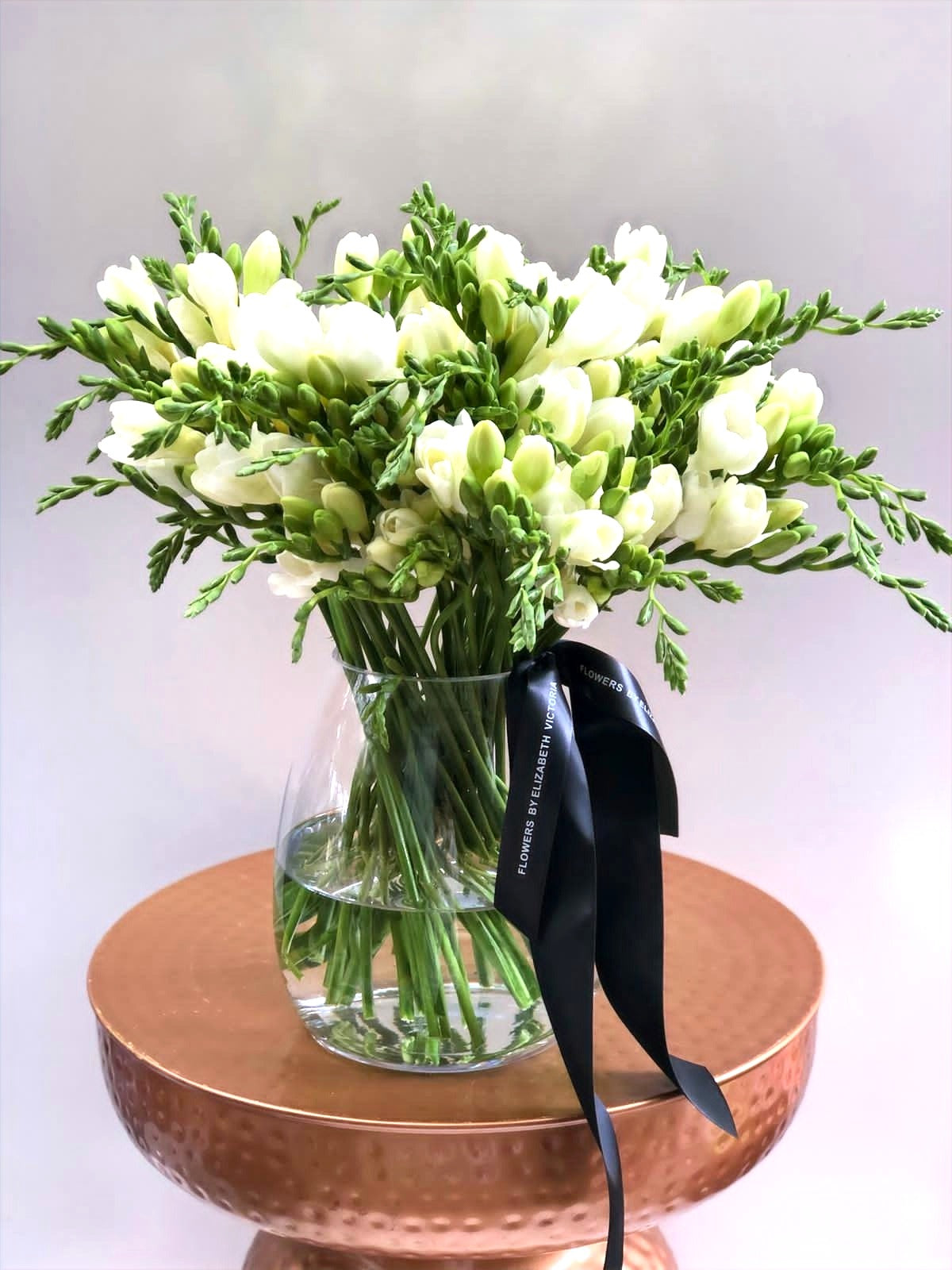Fragrant Freesias in Glass Vase
